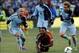 Dec 7, 2013; Kansas City, KS, USA; Real Salt Lake forward Robbie Findley (middle) falls while chasing the ball with Sporting KC defender Aurelien Collin (left) and defender/midfielder Chance Myers (right) in the first half of the 2013 MLS Cup at Sporting