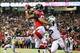 Oct 7, 2013; Atlanta, GA, USA; Atlanta Falcons tight end Levine Toilolo (80) catches a touchdown pass over New York Jets safety Dawan Landry (26) in the second half at the Georgia Dome. The Jets won 30-28. Mandatory Credit: Daniel Shirey-USA TODAY Sports