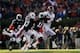 AUBURN, AL - NOVEMBER 30: T.J. Yeldon #4 of the Alabama Crimson Tide runs the ball against the defense of Robenson Therezie #27 and Chris Davis #11 of the Auburn Tigers in the first quarter at Jordan-Hare Stadium on November 30, 2013 in Auburn, Alabama.