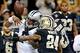 Dec 8, 2013; New Orleans, LA, USA; Carolina Panthers quarterback Cam Newton (1) fumbles out of bounds as he is hit by New Orleans Saints cornerback Corey White (24) and free safety Malcolm Jenkins (27) during the first quarter of a game at Mercedes-Benz S