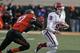 STILLWATER, OK - DECEMBER 7: Quarterback Trevor Knight #9 of the Oklahoma Sooners scrambles away from safety Lyndell Johnson #27 of the Oklahoma State Cowboys December 7, 2013 at Boone Pickens Stadium in Stillwater, Oklahoma. Oklahoma defeated Oklahoma