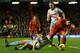 LIVERPOOL, ENGLAND - DECEMBER 07: Luis Suarez of Liverpool competes with Kevin Nolan of West Ham United during the Barclays Premier League match between Liverpool and West Ham United at Anfield on December 7, 2013 in Liverpool, England. (Photo by Clive