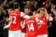 LONDON, ENGLAND - DECEMBER 08: Mesut Oezil of Arsenal celebrates scoring their first goal with team mates during the Barclays Premier League match between Arsenal and Everton at Emirates Stadium on December 8, 2013 in London, England. (Photo by Michael