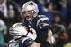 Dec 8, 2013; Foxborough, MA, USA; New England Patriots quarterback Tom Brady (12) leaps into the arms of center Ryan Wendell (62) after he threw the winning touchdown pass during the fourth quarter of New England's 27-26 win over the Cleveland Browns at G