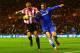 SUNDERLAND, ENGLAND - DECEMBER 04: Wes Brown of Sunderland challenges for the ball with Fernando Torres of Chelsea during the Barclays Premier League match between Sunderland and Chelsea at Stadium of Light on December 4, 2013 in Sunderland, England. (Ph