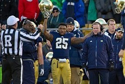 Nov 2, 2013; South Bend, IN, USA; Notre Dame Fighting Irish running back Tarean Folston (25) reacts as referee Ed Ardito announces the result of a reviewed play in the fourth quarter against the Navy Midshipmen at Notre Dame Stadium. Notre Dame won 38-34.