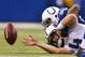 INDIANAPOLIS, IN - DECEMBER 01: Ryan Fitzpatrick #4 of the Tennessee Titans reaches for a fumble while being tackled by Josh Chapman #96 of the Indianapolis Colts during the third quarter at Lucas Oil Stadium on December 1, 2013 in Indianapolis, Indiana.