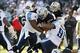 Nov 24, 2013; Oakland, CA, USA; Oakland Raiders running back Rashad Jennings (27) is tackled by Tennessee Titans defensive tackle Sammie Lee Hill (94) and defensive end Derrick Morgan (91) in the first quarter at O.co Coliseum. Mandatory Credit: Cary Edmo