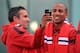 MANCHESTER, ENGLAND - MAY 13: Manchester United's Robin Van Persie and Ashley Young photograph the fans from an open-top bus at the start of their Barclays Premier League Trophy Parade through Manchester on May 13, 2013 in Manchester, England. (Photo b