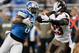 DETROIT, MI - NOVEMBER 24: (EDITORS NOTE: Retransmission with alternate crop.) Calvin Johnson #81 of the Detroit Lions stiff arms Mark Barron #23 of the Tampa Bay Buccaneers after a second quarter catch at Ford Field on November 24, 2013 in Detroit, Michi