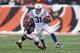 CINCINNATI, OH - DECEMBER 08: Donald Brown #31 of the Indianapolis Colts runs with the ball while defended by James Harrison #92 of the Cincinnati Bengals during the NFL game at Paul Brown Stadium on December 8, 2013 in Cincinnati, Ohio. (Photo by Andy L