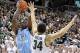 Dec 4, 2013; East Lansing, MI, USA; North Carolina Tar Heels forward Joel James (42) shoots over Michigan State Spartans forward Gavin Schilling (34) during the 1st half a game at Jack Breslin Student Events Center. Mandatory Credit: Mike Carter-USA TODAY