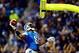 Nov 28, 2013; Detroit, MI, USA; Detroit Lions wide receiver Calvin Johnson (81) dunks the football over the goal post after scoring a touchdown during the third quarter of a NFL football game against the Green Bay Packers on Thanksgiving at Ford Field. Ma
