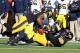 Nov 23, 2013; Iowa City, IA, USA; Michigan Wolverines quarterback Devin Gardner (98) is sacked by Iowa Hawkeyes linebacker Christian Kirksey (20) and left tackle Carl Davis (71) at Kinnick Stadium. Iowa beat Michigan 24-21. Mandatory Credit: Reese Strick