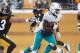 PITTSBURGH, PA - DECEMBER 08: Lamar Miller #26 of the Miami Dolphins avoids the reach of Troy Polamalu #43 of the Pittsburgh Steelers at Heinz Field on December 8, 2013 in Pittsburgh, Pennsylvania. Miami won the game 34-28. (Photo by Gregory Shamus/Getty