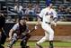 NEW YORK, NY - JULY 23: Ike Davis #29 of the New York Mets hits an RBI double as Brian McCann #16 of the Atlanta Braves defends on July 23, 2013 at Citi Field in the Flushing neighborhood of the Queens borough of New York City. (Photo by Elsa/Getty Imag