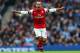 MANCHESTER, ENGLAND - DECEMBER 14: Theo Walcott of Arsenal celebrates scoring their first goal during the Barclays Premier League match between Manchester City and Arsenal at Etihad Stadium on December 14, 2013 in Manchester, England. (Photo by Clive Brun