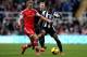 NEWCASTLE UPON TYNE, ENGLAND - DECEMBER 14: Vurnon Anita of Newcastle United looses position under pressure from James Ward-Prowse of Southampton during the Barclays Premier League match between Newcastle United and Southampton at St James' Park on Dece