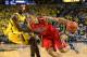 ANN ARBOR, MI - DECEMBER 14: Brandon Ashley #21 of the Arizonia Wilcats drives the ball around Caris Levert #23 of the Michigan Wolverines during the first half of the game at Crisler Center on December 14, 2013 in Ann Arbor, Michigan. (Photo by Leon Hal