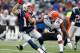 Dec 8, 2013; Foxborough, MA, USA; New England Patriots wide receiver Julian Edelman (11) is tackled by Cleveland Browns defensive back Johnson Bademosi (24) during the second quarter at Gillette Stadium. Mandatory Credit: Stew Milne-USA TODAY Sports