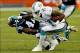 Nov 24, 2013; Miami Gardens, FL, USA; Miami Dolphins wide receiver Mike Wallace (11) stiff arms Carolina Panthers cornerback Captain Munnerlyn (41) in the second half of a game at Sun Life Stadium. The Panthers won 20-16. Mandatory Credit: Robert Mayer-US