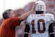 COLLEGE STATION, TX - NOVEMBER 25: Head coach Mack Brown of the Texas Longhorns pats Vince Young #10 on the head during play against the Texas A&M Aggies on November 25, 2005 at Kyle Field in College Station, Texas. The Longhorns defeated the Aggies 40-
