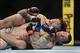 December 14, 2013; Sacramento, CA, USA; Scott Jorgensen (red gloves) fights Zach Makovsky (blue gloves) during the flyweight bout of the UFC on FOX 9 at Sleep Train Arena. Mandatory Credit: Kyle Terada-USA TODAY Sports