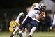 Dec 14, 2013; Hammond, LA, USA; New Hampshire Wildcats quarterback Sean Goldrich (5) carries the ball in front of Southeastern Louisiana Lions linebacker Isaiah Corbett (6) in the first half at Strawberry Stadium. Mandatory Credit: Crystal LoGiudice-USA T