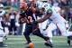 CINCINNATI, OH - OCTOBER 27: BenJarvus Green-Ellis #42 of the Cincinnati Bengalsruns with the ball while defended by Sheldon Richardson #91 of the New York Jets during the game at Paul Brown Stadium on October 27, 2013 in Cincinnati, Ohio. (Photo by And