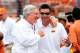 AUSTIN, TX - NOVEMBER 16: Mike gundy, head coach of the Oklahoma State Cowboys, and Mack Brown, head coach the Texas Longhorns, meet at midfield prior to a game at Darrell K Royal-Texas Memorial Stadium on November 16, 2013 in Austin, Texas. Oklahoma St