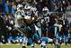Dec 15, 2013; Charlotte, NC, USA; Carolina Panthers cornerback Captain Munnerlyn (41) returns an interception for a touchdown as New York Jets wide receiver Santonio Holmes (10) defends in the fourth quarter at Bank of America Stadium. Mandatory Credit: B