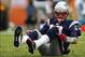 Dec 15, 2013; Miami Gardens, FL, USA: New England Patriots quarterback Tom Brady (12) on the ground after a sack by Miami Dolphins defensive end Cameron Wake (not pictured) in the second half at Sun Life Stadium. The Dolphins won 24-20. Mandatory Credit: