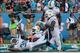 Dec 15, 2013; Miami Gardens, FL, USA: Miami Dolphins defensive back Michael Thomas (center) reacts with strong safety Chris Clemons (30) and defensive end Dion Jordan (95) after his interception of New England Patriots quarterback Tom Brady (not pictured