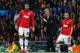 MANCHESTER, ENGLAND - DECEMBER 10: Robin van Persie (L) and Tom Cleverley of Manchester United prepare to come on as substitutes as Manager David Moyes looks on during the UEFA Champions League Group A match between Manchester United and Shakhtar Donets