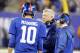 Oct 21, 2013; East Rutherford, NJ, USA; New York Giants offensive coordinator Kevin Gilbride (center) talks to quarterback Eli Manning (10) as Tom Coughlin listens during the second half against the Minnesota Vikings at MetLife Stadium. New York Giants d