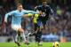 MANCHESTER, ENGLAND - NOVEMBER 24: Emmanuel Adebayor of Tottenham Hotspur is challenged by Martin Demichelis of Manchester City during the Barclays Premier League match between Manchester City and Tottenham Hotspur at Etihad Stadium on November 24, 2013