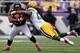 BALTIMORE, MD - OCTOBER 13: Running back Ray Rice #27 of the Baltimore Ravens is tackled by linebacker Jamari Lattimore #57 of the Green Bay Packers in the first quarter at M&T Bank Stadium on October 13, 2013 in Baltimore, Maryland. (Photo by Patrick Smi