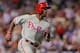 DENVER, CO - JUNE 14: Jimmy Rollins #11 of the Philadelphia Phillies heads for first base as he hits a pinch hit RBI single to score Freddy Galvis #13 of the Philadelphia Phillies and take an 8-7 lead over the Colorado Rockies in the seventh inning at Co