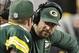 Dec 15, 2013; Arlington, TX, USA; Green Bay Packers quarterback Aaron Rodgers (12) talks with quarterback Matt Flynn (10) on the bench during the game against the Dallas Cowboys at AT&T Stadium. Packers beat the Cowboys 37-36. Mandatory Credit: Tim Heitm