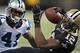 NEW ORLEANS, LA - DECEMBER 8: Marques Colston #12 of the New Orleans Saints is hit after catching a pass by Captain Munnerlyn #41 of the Carolina Panthers at Mercedes-Benz Superdome on December 8, 2013 in New Orleans, Louisiana. The Saints defeated the
