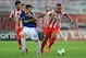 PIRAEUS, GREECE - AUGUST 25: Konstantinos Mitroglou (R) of Olympiacos FC in action against Garcia Miguel Sebastian of Atromitos FC during the greek Super League match between Olympiacos FC and Atromitos FC at Karaiskakis Stadium on August 25, 2013 in Pir