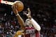 Dec 1, 2013; Miami, FL, USA; Miami Heat point guard Mario Chalmers (15) is fouled by Charlotte Bobcats center Al Jefferson (25) in the second half at American Airlines Arena. The Heat won 99-98. Mandatory Credit: Robert Mayer-USA TODAY Sports