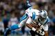 NEW ORLEANS, LA - DECEMBER 08: Cam Newton #1 of the Carolina Panthers is tackled by Malcolm Jenkins #27 of the New Orleans Saints at Mercedes-Benz Superdome on December 8, 2013 in New Orleans, Louisiana. (Photo by Chris Graythen/Getty Images)