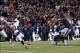 Nov 24, 2013; Foxborough, MA, USA; New England Patriots kicker Stephen Gostkowski (3) kicks the game winning field goal past Denver Broncos cornerback Tony Carter (32) during overtime at Gillette Stadium Stadium. Mandatory Credit: Greg M. Cooper-USA TODAY