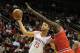 HOUSTON, TX - DECEMBER 18: Chandler Parsons #25 of the Houston Rockets drives with the ball against Luol Deng #9 of the Chicago Bulls during the game at Toyota Center on December 18, 2013 in Houston, Texas. NOTE TO USER: User expressly acknowledges and a