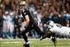Dec 8, 2013; New Orleans, LA, USA; New Orleans Saints quarterback Drew Brees (9) carries the ball before being tripped up by Carolina Panthers defensive end Charles Johnson (95) in the first quarter at the Mercedes-Benz Superdome. Mandatory Credit: Crysta
