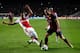 AMSTERDAM, NETHERLANDS - NOVEMBER 26: Ricardo Van Rhijn of Ajax tackles Andres Iniesta of Barcelona during the UEFA Champions League Group H match between Ajax Amsterdam and FC Barcelona at Amsterdam Arena on November 26, 2013 in Amsterdam, Netherlands.