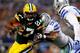ARLINGTON, TX - DECEMBER 15: Running back Eddie Lacy #27 of the Green Bay Packers runs with the ball as defensive end George Selvie #99 of the Dallas Cowboys defends during a game at AT&T Stadium on December 15, 2013 in Arlington, Texas. (Photo by Tom P