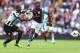 BIRMINGHAM, ENGLAND - SEPTEMBER 14: Christian Benteke of Aston Villa tangles with Mapou Yanga-Mbiwa of Newcastle United during the Barclays Premier League match between Aston Villa and Newcastle United at Villa Park on September 14, 2013 in Birmingham, E