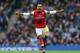 MANCHESTER, ENGLAND - DECEMBER 14: Theo Walcott of Arsenal celebrates after scoring his first goal during the Barclays Premier League match between Manchester City and Arsenal at Etihad Stadium on December 14, 2013 in Manchester, England. (Photo by Cli